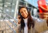 4 Travel Tips for Secure Client Communications Woman at airport with headphones, giving travel tips to clients