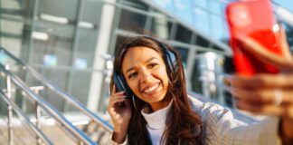 4 Travel Tips for Secure Client Communications Woman at airport with headphones, giving travel tips to clients
