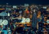 5G Technology and Its Impact on Business Networking city skyline at night with symbols and 5G technology icons over the horizon
