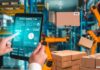 The Impact of AI on Logistics and Supply Chain Efficiency Warehouse and tablet showing impact of AI on logistics, with boxes