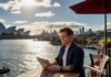 Search Engine Optimization in Sydney in 2025: Leveraging AI Man working on laptop in Sydney in 2025 in front of the opera house