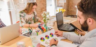 Streamlining Design Revisions in Creative Agencies with Markup Tools Creative team working on design revisions on a table