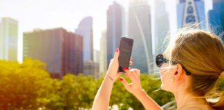 Top Web & Mobile App Development in Dubai & Abu Dhabi | CodeGuru.ae woman using app development in Dubai on smartphone