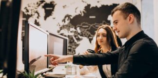 How to Find and Hire the Best App Developers: A Guide from Mobilunity two developers looking at screens to find and hire more app developers