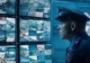 Seamless Operations: Unifying Payroll and Billing in Security Services Guard conducting seamless operations with cameras on screens