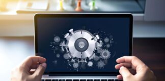 Website Load Testing: The Best Tools website load shown with a gear graphic on a laptop