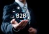 Unlock the Secrets to B2B Success: How Companies Redefine Growth in 2025 businessman holding hand out with B2B success graphic floating above