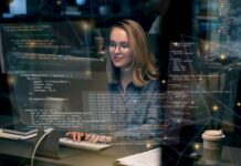 React vs. Vue: Choosing the Right Frontend Framework in 2025 React Vs. Vue frontend framework, with woman programmer on desktop computers