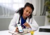 Top Healthcare Mobile App Trends You Should Consider in 2025 doctor using a healthcare mobile app with a patient