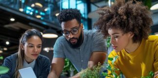 Healthy Habits for People Working in Tech Tech workers having healthy habits at work, looking at laptop and drinking water