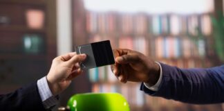 Ways Business Cards Can Fulfil Multiple Purposes in One Solution two men exchanging business cards for multiple purposes