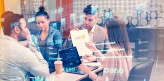 How Tech Startups Can Create Investor-Friendly Pitch Decks tech startup working on pitch deck at table, with graphics in foreground