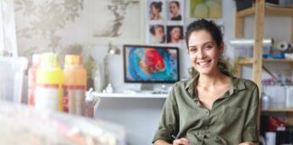 How Small Businesses Can Make the Most of Swag on a Budget smiling woman sitting in her business helping small businesses