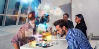 Cyber Insurance 101: Why Every Tech Startup Needs Protection people from a tech startup around table, with innovative images in foreground