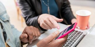 10 Questions to Ask Before Choosing an SMS Payment Provider two people using SMS payment provider on smartphone and laptop