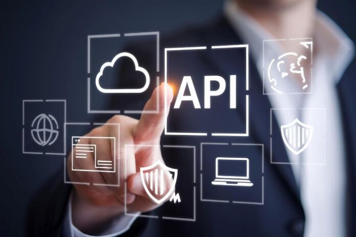 Person touching API icon on screen in foreground, for Zuplo API