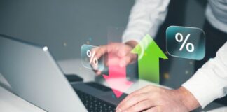 Top 9 Conversion Rate Optimization TipsĀ man on laptop looking at conversion rates with up and down arrows in foreground