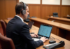 How Technology Is Transforming How Court Reporting Is Done court reporting, shown with man at table in courtroom with technology