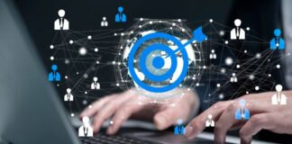 Why Most Businesses Struggle with Lead Generation marketing professional typing on laptop for lead generation, with blue target in foreground