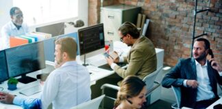 Outsourcing Benefits To Grow Your Franchise Business a business outsourcing center with several people working at desks