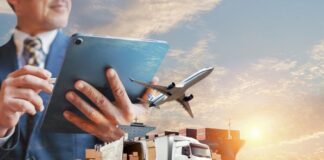 Delivery Planning Software is Revolutionizing Logistics and Efficiency delivery planning software used by manager on tablet, with small truck, plane and boxes in background