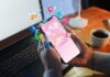How to Boost Your Social Media Engagement in 2025 hands holding smartphone with social media engagement icons