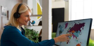 Why Every Business Needs Enterprise Translation Services? Key Reasons woman in office using enterprise translation services while using a desktop computer with map