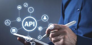 The Economics of API Automation: Cost Savings and Efficiency GainsĀ API automation with person on tablet and icons in foreground