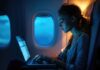 From App to Altitude: Advanced Tech Streamlines Private Jet Charters woman using advanced tech with her laptop on an airline flight