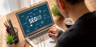 Elevate Your Brand Visibility: The Role of SEO Tools in Online Marketing brand visibility driven by SEO, shown with person on laptop