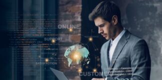 Why You Should Be Embracing Technology for Your Business business embracing technology, with man on laptop and globe in foreground