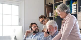 HR Practices and Employee Expectations in a Multi-Generational Workplace diverse tech workers meeting employee expectations at desk with laptop