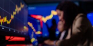 Cryptocurrency Fundamental Analysis: How to Evaluate Projects That Last crypto trader using fundamental analysis, in front of screens with bitcoin in foreground