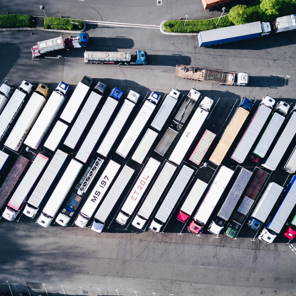 cutting fleet costs, shown with overhead shot of 50 trucks