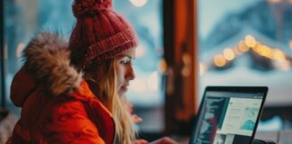Mastering Digital Marketing in Toronto’s Fast-Paced Business Landscape woman mastering digital marketing on laptop. she is wearing red down coat and hat