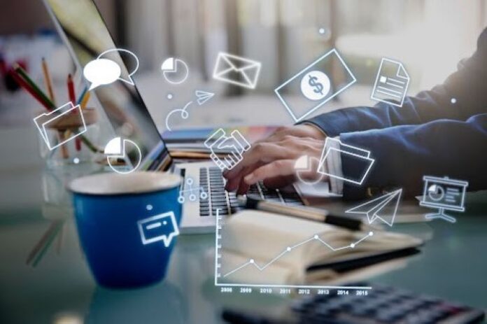 modern marketers working on laptop with icons in foreground