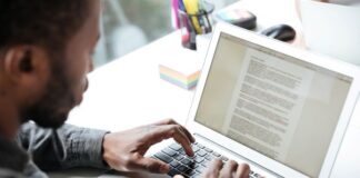 New Study: Best Ways to Organize Writing Projects organize writing on a laptop, shown with man typing a paper