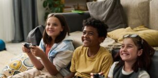 How to Stop Kids from Spending $300 on “Smurfberries” parents have controls on games to stop kids from spending, shown with three children with controllers