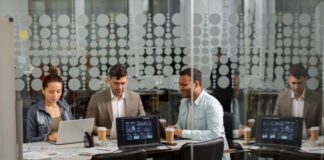 Modern IT Delivery: How Managed Services Are Evolving Modern IT delivery with team in room with laptops