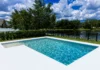 Fibreglass Swimming Pools In Liverpool, NSW: High-Tech Features swimmming pool with a fence surroundiings