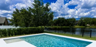 Fibreglass Swimming Pools In Liverpool, NSW: High-Tech Features swimmming pool with a fence surroundiings