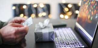 How Loyalty Program Software Can Drive Long-Term Business Growth man with gift using loyalty program on laptop