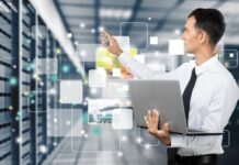 Top 5 Benefits of Outsourcing IT Management outsourcing IT management with worker on server