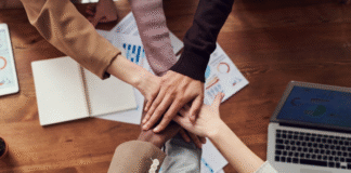 7 Ways to Foster Workplace Belonging with Innovative Traditions workplace belonging with workers joining hands