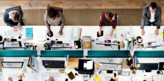 A Guide to Implementing Modern Workplace Solutions Smoothly modern workplace solutions aerial view of big desk