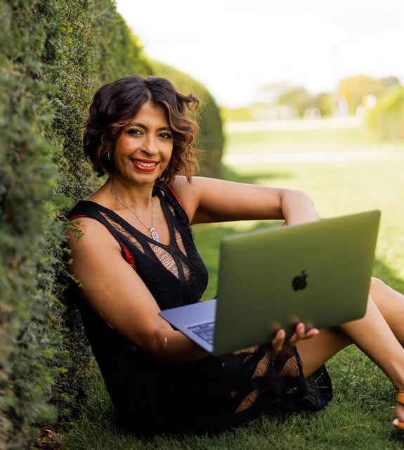 Vidya Ramanathan sitting in black dress with laptop