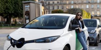 EV Tech Diagnostics: Tackling EV Boom’s Hidden Hurdle girl standing next to EV diagnostics vehicle