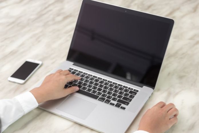 person researching pros and cons of laptops