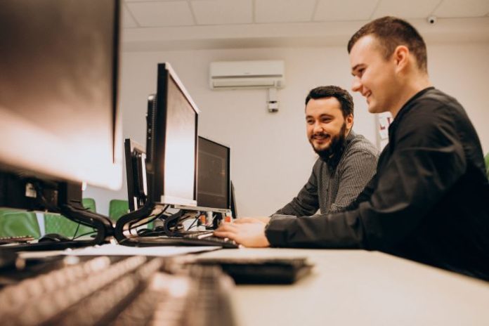 young individuals working with it support