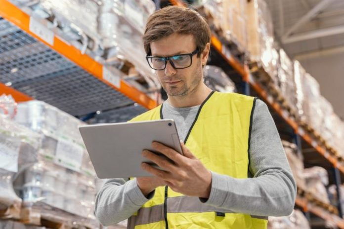 person in hardware store using logistics software